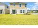 Expansive backyard with green lawn, patio, and view of the home's exterior at 12908 Hawkstone Trail Blvd, Lithia, FL 33547