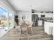 Sunlit dining area with backyard view, featuring stylish decor and seating adjacent to the open kitchen at 12908 Hawkstone Trail Blvd, Lithia, FL 33547
