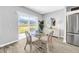 Bright dining area with sliding glass doors to the backyard, complemented by a stylish table and plenty of natural light at 12908 Hawkstone Trail Blvd, Lithia, FL 33547