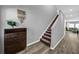 Inviting entryway featuring hardwood floors, a staircase, and decorative accents at 12908 Hawkstone Trail Blvd, Lithia, FL 33547