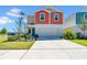 Inviting two-story home featuring a two-car garage, colorful siding and a well-manicured lawn at 12908 Hawkstone Trail Blvd, Lithia, FL 33547