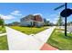 Charming two-story home with a colorful exterior and well-maintained lawn on a sunny corner lot at 12908 Hawkstone Trail Blvd, Lithia, FL 33547