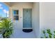 Welcoming exterior of home featuring a blue front door, and lush green landscaping at 12908 Hawkstone Trail Blvd, Lithia, FL 33547
