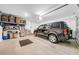 Spacious two-car garage with ample storage shelving and overhead lighting at 12908 Hawkstone Trail Blvd, Lithia, FL 33547
