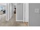 Hallway with neutral walls and carpet, showcasing access to other rooms in the home at 12908 Hawkstone Trail Blvd, Lithia, FL 33547