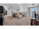 Cozy living room featuring plush carpeting, a comfortable sofa, and lots of natural light at 12908 Hawkstone Trail Blvd, Lithia, FL 33547