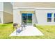 Outdoor patio with seating area, sliding glass doors leading into home, and green grass at 12908 Hawkstone Trail Blvd, Lithia, FL 33547