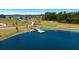Scenic view of a tranquil community pond featuring a wooden dock, walking paths and lush landscaping at 12908 Hawkstone Trail Blvd, Lithia, FL 33547