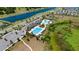 Aerial view of the community pool featuring a lap pool, leisure pool, clubhouse and ample parking at 12908 Hawkstone Trail Blvd, Lithia, FL 33547