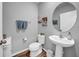 Charming powder room with pedestal sink, round mirror, and beach-themed artwork at 12908 Hawkstone Trail Blvd, Lithia, FL 33547