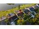 Aerial view of homes and neighborhood featuring a lake, pools and well-manicured lawns at 12918 Royal George Ave, Odessa, FL 33556