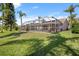 Spacious backyard featuring a screened-in pool and lush green lawn, creating a private outdoor oasis at 12918 Royal George Ave, Odessa, FL 33556