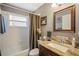 Cozy bathroom with granite countertop, and a shower and tub combo at 12918 Royal George Ave, Odessa, FL 33556