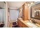 Bathroom featuring double sinks with granite countertops and decorative mirrors at 12918 Royal George Ave, Odessa, FL 33556