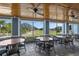 A bright dining area overlooking the golf course boasts large windows and comfortable seating at 12918 Royal George Ave, Odessa, FL 33556