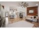 Open-concept living room showcases hardwood floors, a large ceiling fan, and seamless flow to the dining area at 12918 Royal George Ave, Odessa, FL 33556