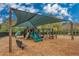 A community playground offers shaded play structures with a soft woodchip surface at 12918 Royal George Ave, Odessa, FL 33556