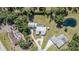 Overhead shot of a home with an in-ground pool and surrounded by mature trees at 1305 Greenfield Cir, Venice, FL 34292