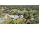 Expansive backyard with pool and lush greenery surrounding this beautiful, serene home and outdoor space at 1305 Greenfield Cir, Venice, FL 34292