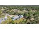 Aerial view of a home surrounded by trees, with a pool and screened-in patio at 1305 Greenfield Cir, Venice, FL 34292