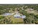 Aerial view of a home nestled in a wooded area with a private circular drive at 1305 Greenfield Cir, Venice, FL 34292