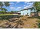 Spacious backyard with partial shade and screened in porch area at 1305 Greenfield Cir, Venice, FL 34292