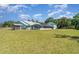 Expansive backyard featuring a screened-in patio and a shed at 1305 Greenfield Cir, Venice, FL 34292