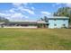 Spacious backyard featuring a screened-in patio and a two-story extension at 1305 Greenfield Cir, Venice, FL 34292