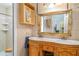 Bathroom featuring an ornate mirror and a stylish, double sink vanity at 1305 Greenfield Cir, Venice, FL 34292