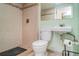 Shower and washroom featuring tiled walls and floors, with a mirror and toilet at 1305 Greenfield Cir, Venice, FL 34292