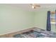 Empty bedroom features light green paint, laminate floors and a modern rug at 1305 Greenfield Cir, Venice, FL 34292