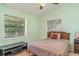Bedroom with two windows, simple decor, and plenty of natural light at 1305 Greenfield Cir, Venice, FL 34292