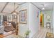 An inviting hallway with exposed brick accents, artwork, and seamless access to the living area at 1305 Greenfield Cir, Venice, FL 34292