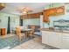 Multi-use living area featuring a bed, table, kitchenette, and an open floor plan at 1305 Greenfield Cir, Venice, FL 34292
