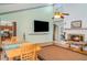 Bright open-plan living area with hardwood floors, a fireplace, and dining space nearby at 1305 Greenfield Cir, Venice, FL 34292