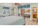 Bright primary bedroom with views from the window and access to the ensuite bathroom at 1305 Greenfield Cir, Venice, FL 34292