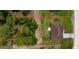 Aerial view of a property lot featuring a home, yard, trees, greenery, and clear boundary lines at 13486 English Sparrow Rd, Weeki Wachee, FL 34614