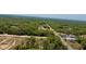 Aerial view of long neighborhood streets filled with trees, greenery, homes, and various properties at 13486 English Sparrow Rd, Weeki Wachee, FL 34614