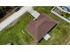Birds eye view of house with a brown roof, green yard, long driveway, and surrounded by trees at 13486 English Sparrow Rd, Weeki Wachee, FL 34614