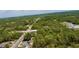 Aerial view of a tree filled neighborhood with homes scattered among the trees and open land at 13486 English Sparrow Rd, Weeki Wachee, FL 34614