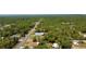 Aerial view of streets running through a neighborhood surrounded by trees, greenery, homes, and properties at 13486 English Sparrow Rd, Weeki Wachee, FL 34614