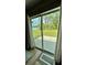 View from the sliding glass doors showcases the expansive backyard and lush greenery at 13486 English Sparrow Rd, Weeki Wachee, FL 34614