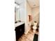 Bright bathroom features a vanity with granite countertop and storage cabinet, plus a toilet and accessories at 13486 English Sparrow Rd, Weeki Wachee, FL 34614