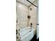 Bright bathroom features a tub with tiled walls, black shower hardware, and a white shower curtain at 13486 English Sparrow Rd, Weeki Wachee, FL 34614