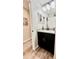 Bright bathroom boasts a vanity with granite countertop and black cabinet, and a modern sink at 13486 English Sparrow Rd, Weeki Wachee, FL 34614
