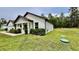 Exterior view of a single-Gathering home with a well-kept lawn and landscaped bushes at 13486 English Sparrow Rd, Weeki Wachee, FL 34614