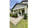 Inviting front porch of home with a well-maintained lawn and beautifully landscaped bushes at 13486 English Sparrow Rd, Weeki Wachee, FL 34614