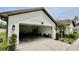 Attached garage showcasing concrete driveway, exterior lighting and landscaping at 13486 English Sparrow Rd, Weeki Wachee, FL 34614