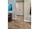 Hallway features wood-look flooring and a double door closet with black hardware at 13486 English Sparrow Rd, Weeki Wachee, FL 34614