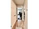 Hallway features wood-look flooring and leads to bedroom, office, and entryway at 13486 English Sparrow Rd, Weeki Wachee, FL 34614